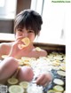 A woman sitting in a bathtub with a slice of lemon in her mouth.