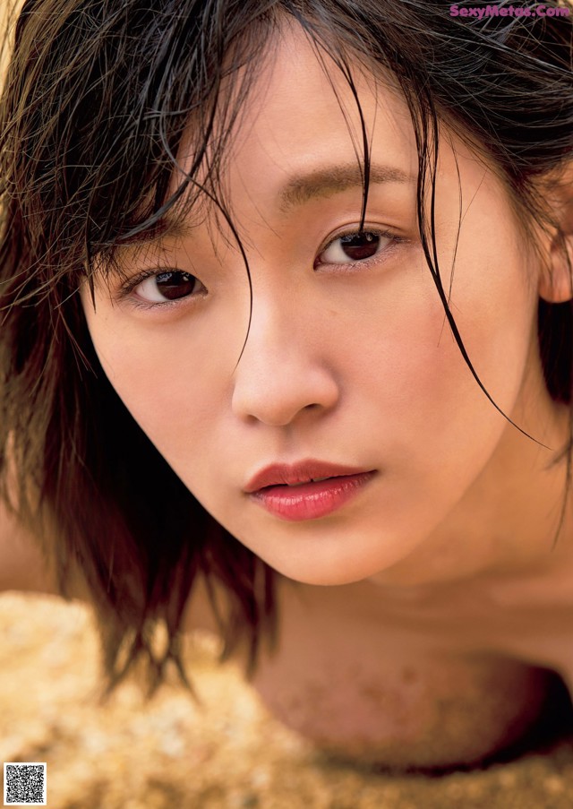A woman with wet hair laying on the ground.
