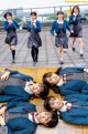 A group of young women in school uniforms posing for a picture.